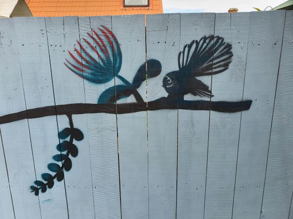 Various New Zealand birds depicted in a fence mural, in silhouette form